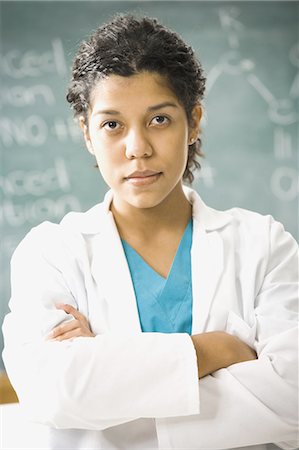 scientist and teacher photo - Female science teacher standing in front of a blackboard Stock Photo - Premium Royalty-Free, Code: 640-03258373