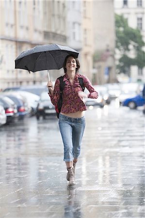 rainy days - Woman walking down the street in the rain Stock Photo - Premium Royalty-Free, Code: 640-03258653