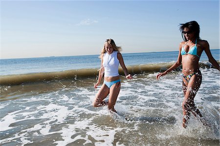 Two women walking in the ocean Stock Photo - Premium Royalty-Free, Code: 640-03258676