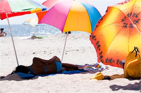 fish lying down - Adults lying under beach umbrellas Stock Photo - Premium Royalty-Free, Code: 640-03258750