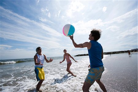 runner women group - Three adults playing with a beach ball Stock Photo - Premium Royalty-Free, Code: 640-03258774