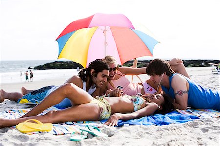 simsearch:640-03258825,k - Four adults lying on the beach Stock Photo - Premium Royalty-Free, Code: 640-03258807