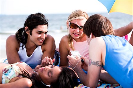 fish lying down - Four adults lying on the beach Stock Photo - Premium Royalty-Free, Code: 640-03258810