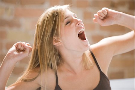 exercise and stretching for girls - Woman yawning and stretching in bed Stock Photo - Premium Royalty-Free, Code: 640-03258942