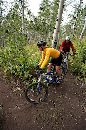 Man and woman biking on path outside Stock Photo - Premium Royalty-Free, Code: 640-03259086