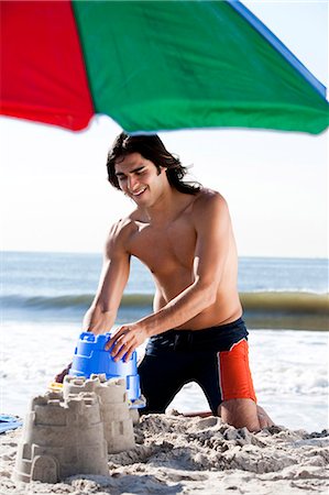 simsearch:640-03259235,k - Man building a sand castle Stock Photo - Premium Royalty-Free, Code: 640-03259168