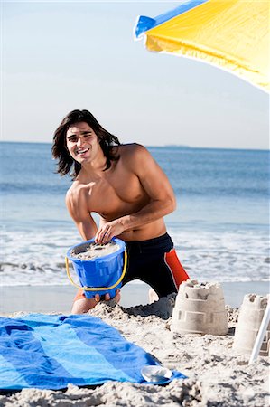 simsearch:640-03259235,k - Man building a sand castle Stock Photo - Premium Royalty-Free, Code: 640-03259169