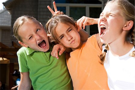 Three girl friends laughing outside Stock Photo - Premium Royalty-Free, Code: 640-03259317