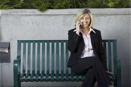 simsearch:640-03259404,k - Businesswoman on cellular sitting on a bench Stock Photo - Premium Royalty-Free, Code: 640-03259478