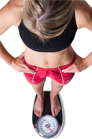 Woman on a weight scale Foto de stock - Sin royalties Premium, Código: 640-03259564