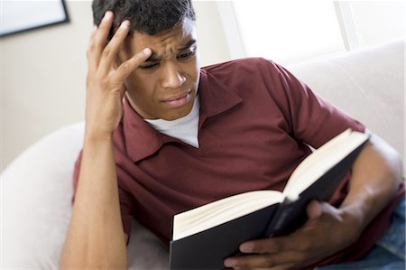 Teenage boy reading a book Stock Photo - Premium Royalty-Free, Code: 640-03259609