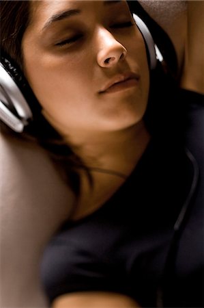 someone laying down aerial view - Woman listening to headphones Stock Photo - Premium Royalty-Free, Code: 640-03259755