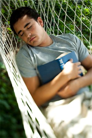 someone laying down aerial view - Man reading in a hammock Stock Photo - Premium Royalty-Free, Code: 640-03259813