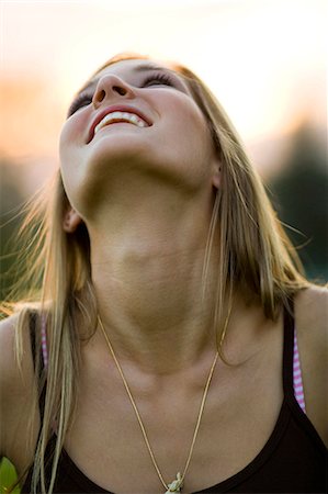 Teenage girl looking up smiling Stock Photo - Premium Royalty-Free, Code: 640-03259868