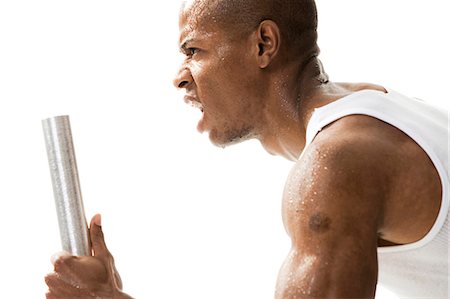 excercise and sweating - Man running with relay baton Stock Photo - Premium Royalty-Free, Code: 640-03259915