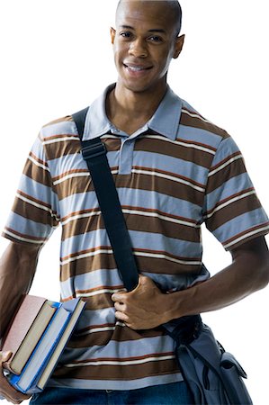 Teenage boy with bookbag and books Stock Photo - Premium Royalty-Free, Code: 640-03259947
