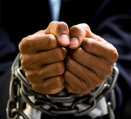 Businessman's hands bound in chains Stock Photo - Premium Royalty-Free, Code: 640-03259965