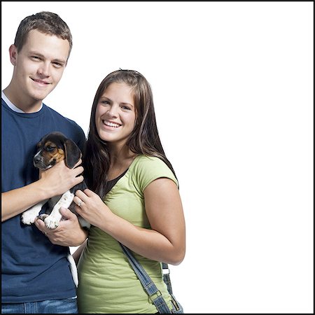 silhouette man woman standing together - Young couple holding a beagle Stock Photo - Premium Royalty-Free, Code: 640-03259984