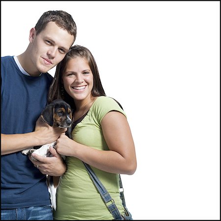 silhouette man woman standing together - Young couple holding a beagle Stock Photo - Premium Royalty-Free, Code: 640-03259985