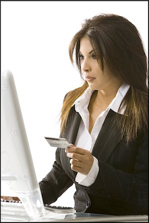 Woman using her credit  card on her computer Stock Photo - Premium Royalty-Free, Code: 640-03264042