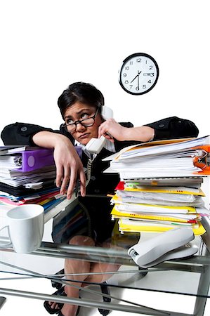 paper stack on white background - Woman on telephone with stack of binders Stock Photo - Premium Royalty-Free, Code: 640-03264405