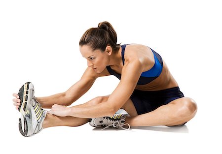 riscaldare - Woman athlete stretching legs Fotografie stock - Premium Royalty-Free, Codice: 640-03264477