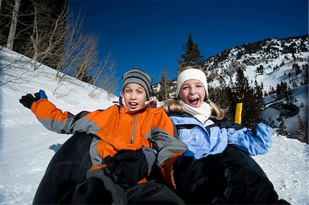 preteen tube - Brother and sister sliding on inner tube Stock Photo - Premium Royalty-Free, Code: 640-03264545