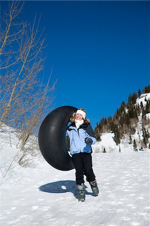 Girl walking with inner tube Stock Photo - Premium Royalty-Free, Code: 640-03264559