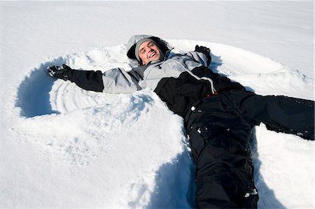 Man making snow angel Stock Photo - Premium Royalty-Free, Code: 640-03264651