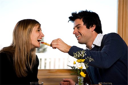 Couple eating at fast food restaurant Stock Photo - Premium Royalty-Free, Code: 640-03264677