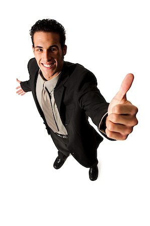 Young businessman giving thumbs up Stock Photo - Premium Royalty-Free, Code: 640-03264705