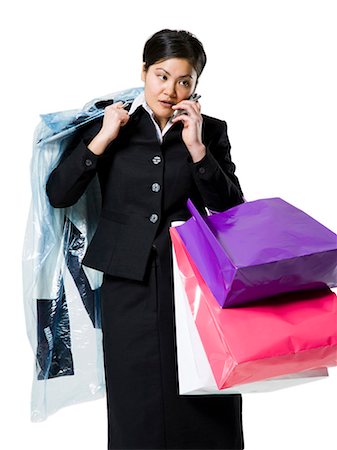 dry-cleaning - Woman with shopping bags and cellphone Stock Photo - Premium Royalty-Free, Code: 640-03264701