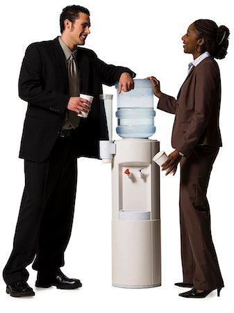 Business people conversing at water cooler Stock Photo - Premium Royalty-Free, Code: 640-03264710