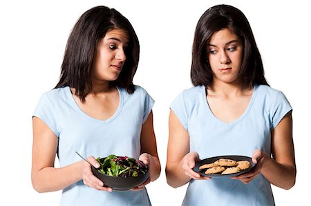 family eating burgers - Sisters offering holding sushi and hamburger Stock Photo - Premium Royalty-Free, Code: 640-03264720