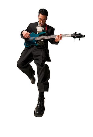 electric bass white background - Man jumping with electric guitar Stock Photo - Premium Royalty-Free, Code: 640-03264765