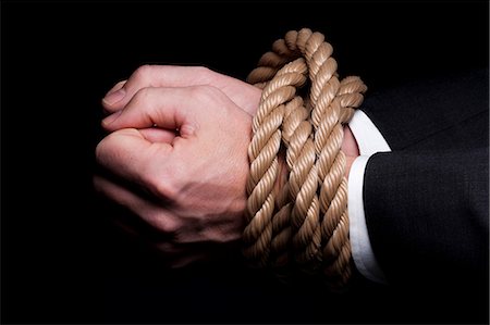 Hands tied at the wrists with rope Stock Photo - Premium Royalty-Free, Code: 640-03264770