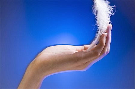 people and air - Hand with floating feather Stock Photo - Premium Royalty-Free, Code: 640-03264789