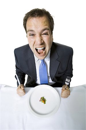 scale (contrast in size) - Overweight businessman eating a small salad Stock Photo - Premium Royalty-Free, Code: 640-03265139