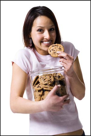 eating cookies - Woman waiting for a call on the telephone Stock Photo - Premium Royalty-Free, Code: 640-03265155