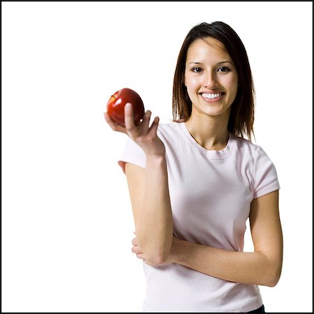 people with fruits cutout - Woman holding a red apple Stock Photo - Premium Royalty-Free, Code: 640-03265162