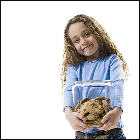 eating cookies - Jeune fille tenant la jarre à biscuits Photographie de stock - Premium Libres de Droits, Code: 640-03265225