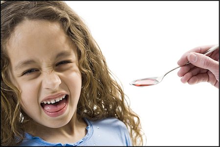 dissatisfied - Young girl taking a spoonful of medicine Stock Photo - Premium Royalty-Free, Code: 640-03265241