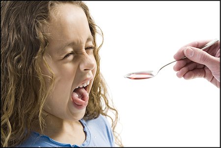 Young girl taking a spoonful of medicine Foto de stock - Sin royalties Premium, Código: 640-03265242