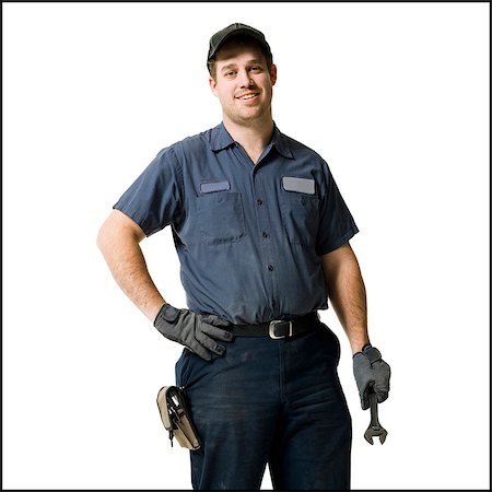 plumber male - Repairman holding a wrench Stock Photo - Premium Royalty-Free, Code: 640-03265434