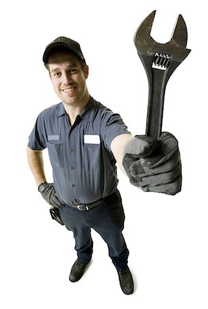 plumbing repairs - Repairman holding a wrench Stock Photo - Premium Royalty-Free, Code: 640-03265435