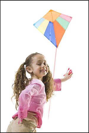 Young girl flying a kite Foto de stock - Sin royalties Premium, Código: 640-03265446