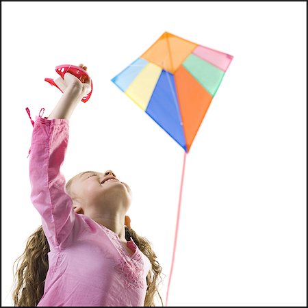 flying kites pictures - Young girl flying a kite Stock Photo - Premium Royalty-Free, Code: 640-03265443