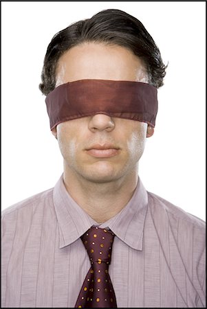 Close-up of a businessman wearing a blindfold Stock Photo - Premium Royalty-Free, Code: 640-03265469