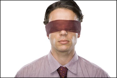 Close-up of a businessman wearing a blindfold Stock Photo - Premium Royalty-Free, Code: 640-03265470