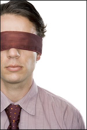 Close-up of a businessman wearing a blindfold Stock Photo - Premium Royalty-Free, Code: 640-03265472